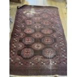 A Persian red ground rug, 204 x 140 cm very worn