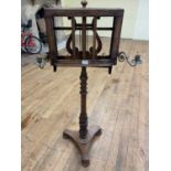 A 19th century mahogany music stand, with gilt metal sconces, on a turned column support, to a
