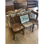 A pine kitchen table, a wall mirror, five chairs, and a print