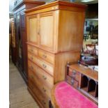 A Heals & Co walnut linen press, the top having two cupboard doors, on a base with two short and