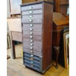 An early 20th century stained pine filing cabinet, with cloth covered cardboard drawers, 48 cm