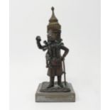 A bronze, in the form of a street seller, on a polished stone base, 21 cm high The box on his