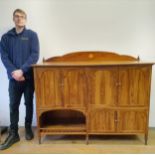 A rosewood sideboard, having eight cupboard doors, 154 cm wide