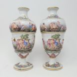 A pair of Continental porcelain vases, decorated classical scenes, 23 cm high Lacking stoppers,