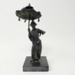 A bronze in the form of an Asian man holding an umbrella, on a polished slate marble base, 20 cm