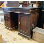 An early 20th century stained pine pedestal desk, the top with two drawers, on pedestals with four