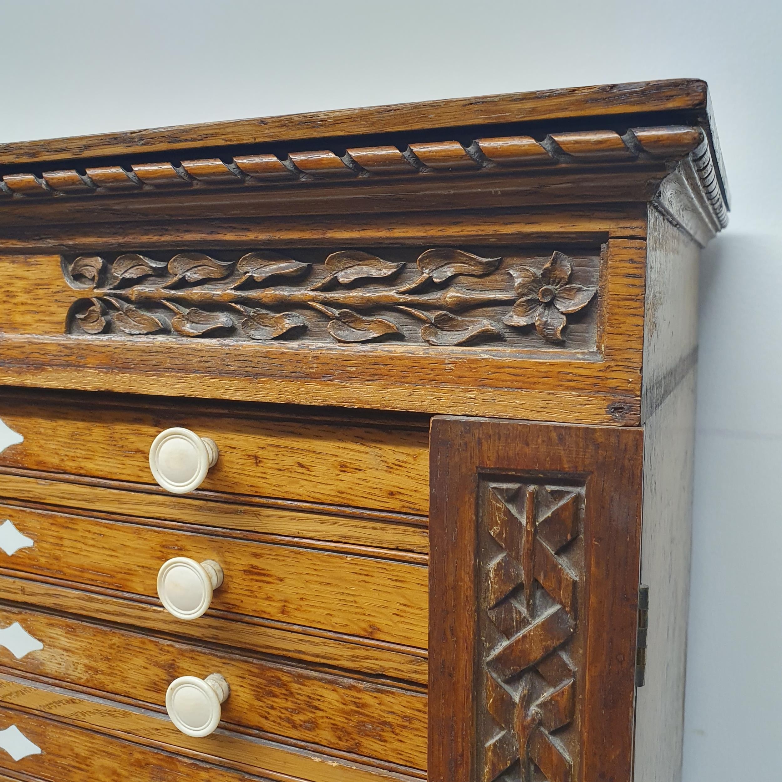 A late 19th century oak collectors chest, with a floral carved frieze, fourteen drawers, 70 cm x - Image 2 of 8