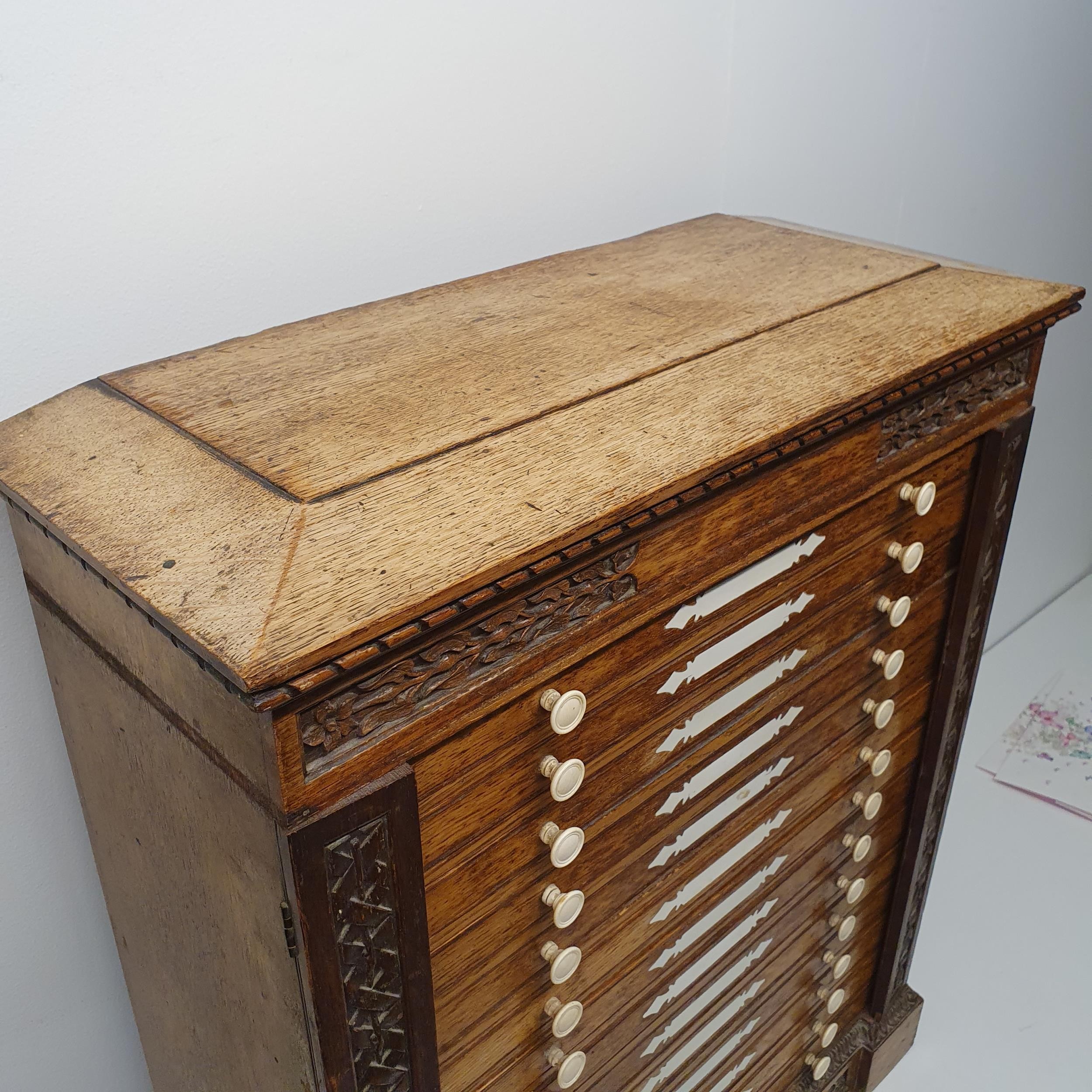 A late 19th century oak collectors chest, with a floral carved frieze, fourteen drawers, 70 cm x - Image 8 of 8