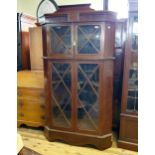 A mahogany free standing corner cupboard, with four glazed doors, 187 cm high x 110 cm wide In