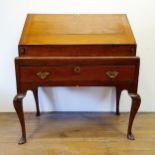 An 18th century oak bureau, a fall front to reveal a fitted interior on a well, all above a single