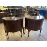 A pair of 1920s walnut bow front cupboards, with single cupboard doors, 85 cm wide