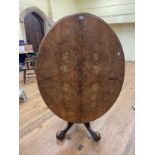 A walnut tilt top oval breakfast table, 140 cm wide