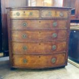 A pollard oak bow front chest, having two short and four long drawers, 112 cm wide Lacking base,