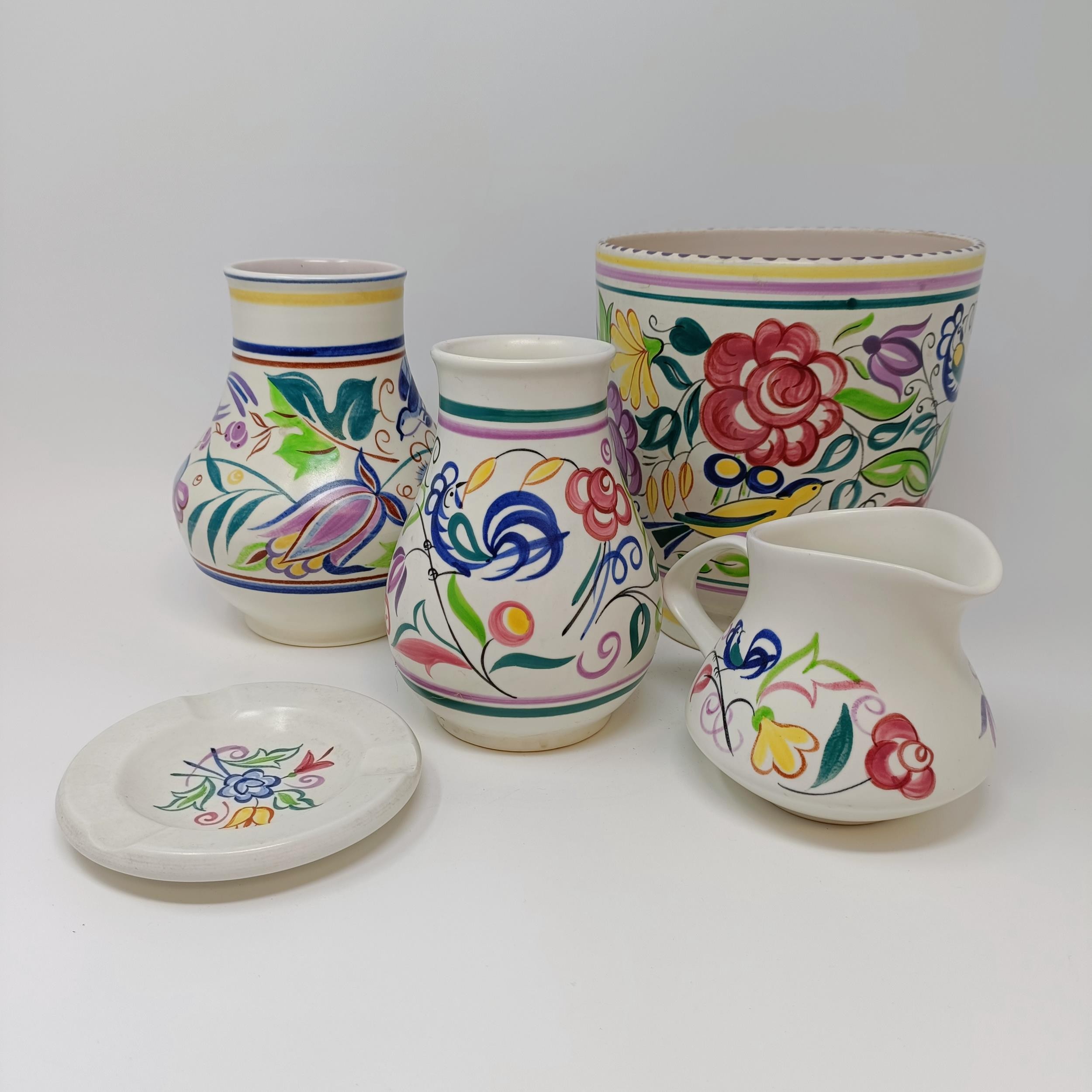 A Poole pottery vase, 18 cm high, two other vases, a jug, and an ashtray (5)