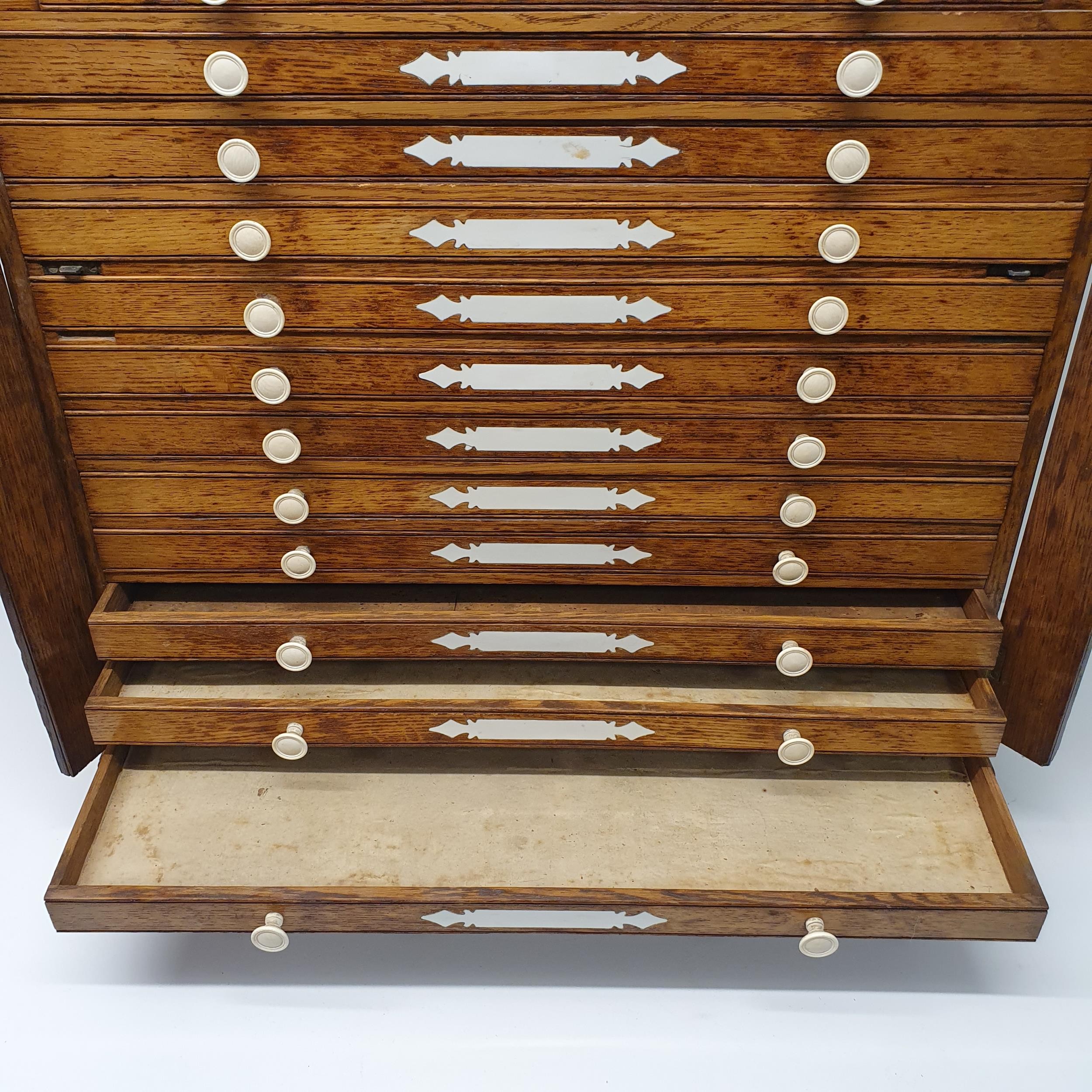 A late 19th century oak collectors chest, with a floral carved frieze, fourteen drawers, 70 cm x - Image 4 of 8