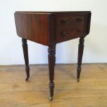 A 19th century mahogany work table, with drop leaves, on turned reeded tapering legs, 52 cm wide