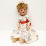 An Armand Marseille German bisque headed doll, No 996, with a jointed composite body, and millefiori
