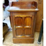 An early 20th century walnut cupboard, with a single door, 60 cm wide