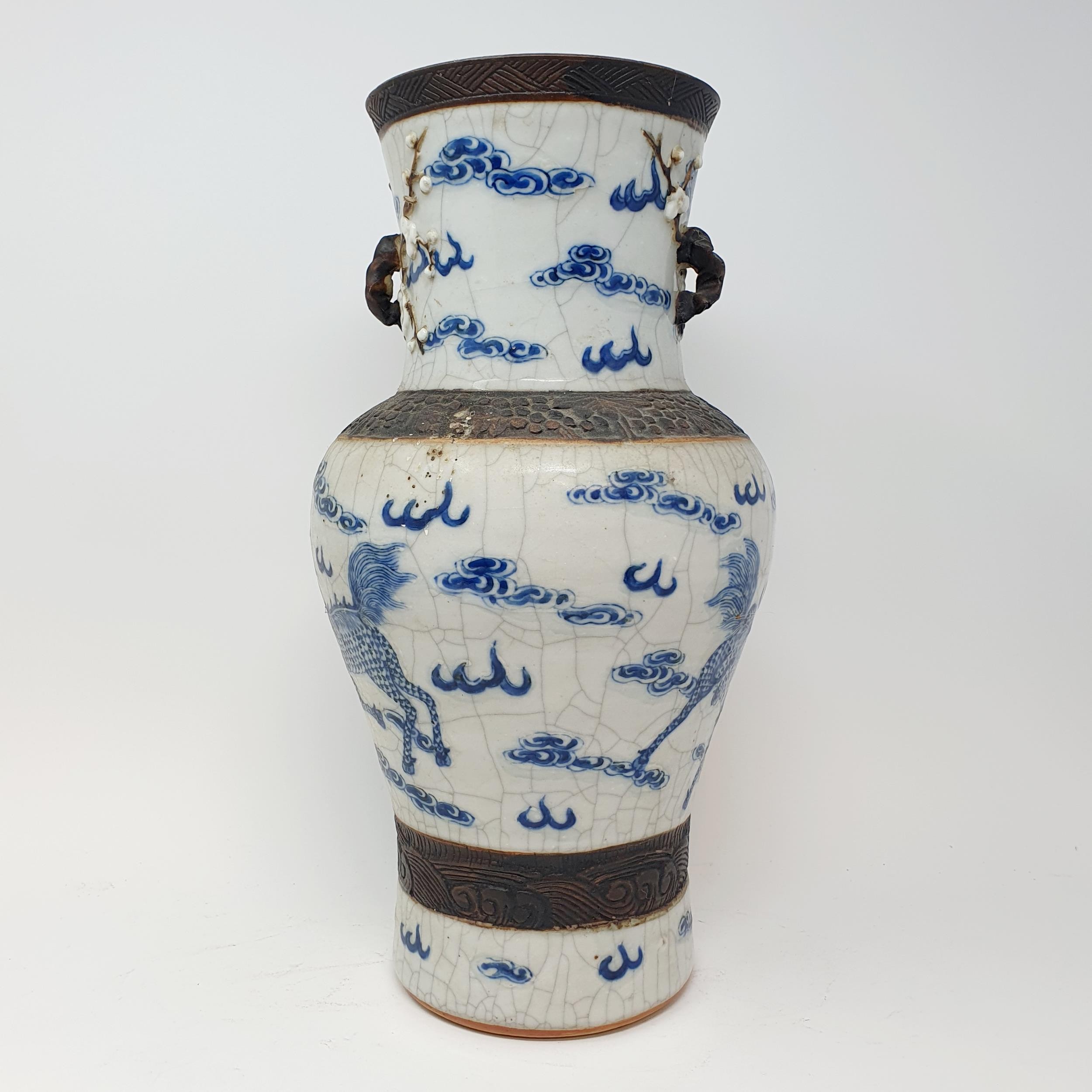 A Chinese underglazed blue and white vase, with a crackled glaze, decorated mythical beasts, 38 cm - Image 6 of 10