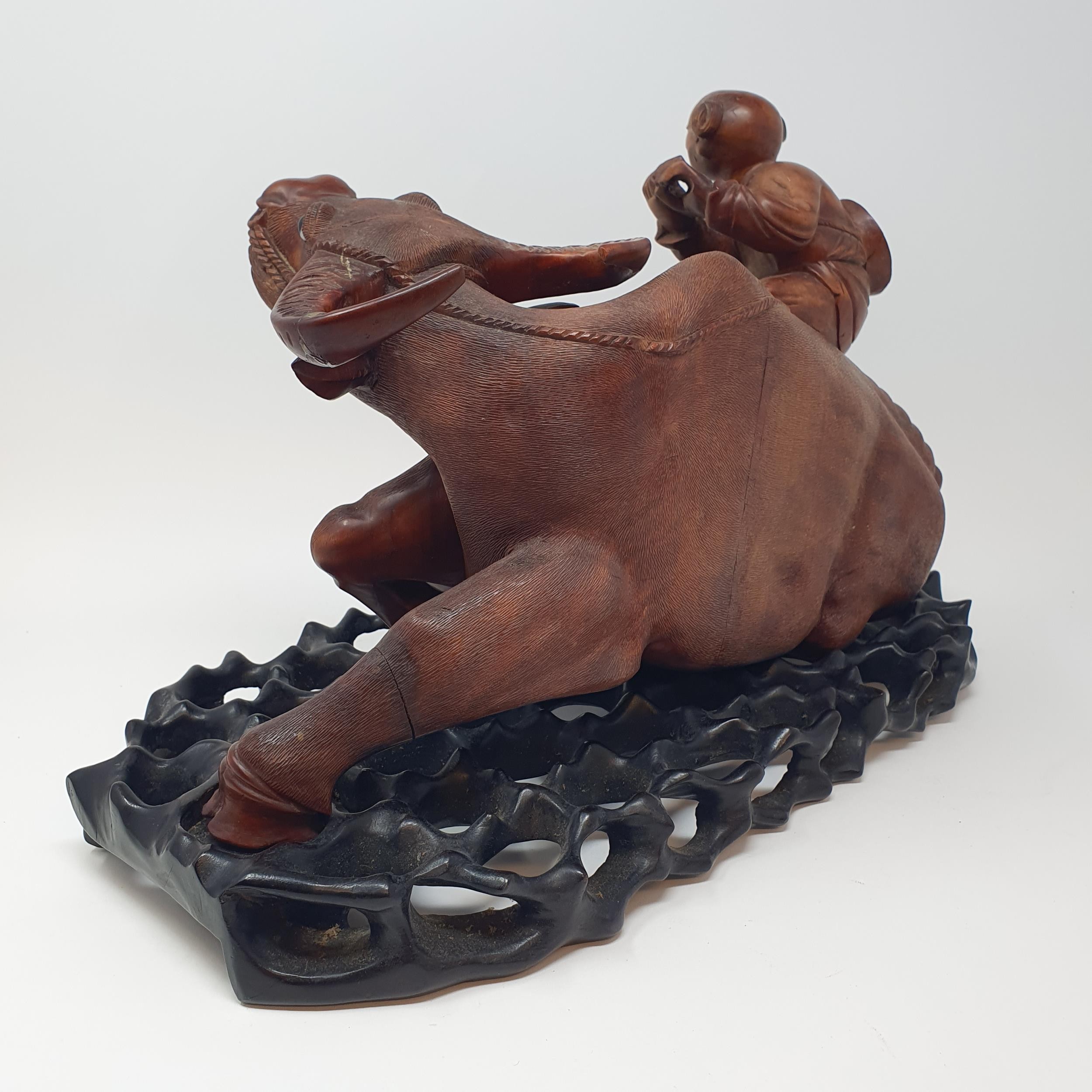 A Chinese carving of a water buffalo, with a seated figure, on a hardwood stand, 40 cm high - Image 5 of 7