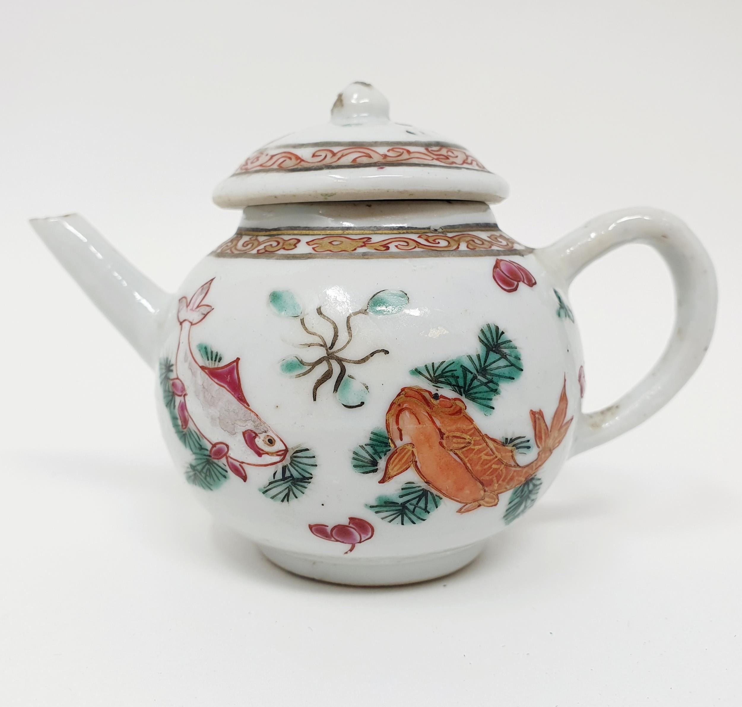 A Chinese porcelain famille rose miniature teapot and cover, decorated carp, 7 cm high The cover: