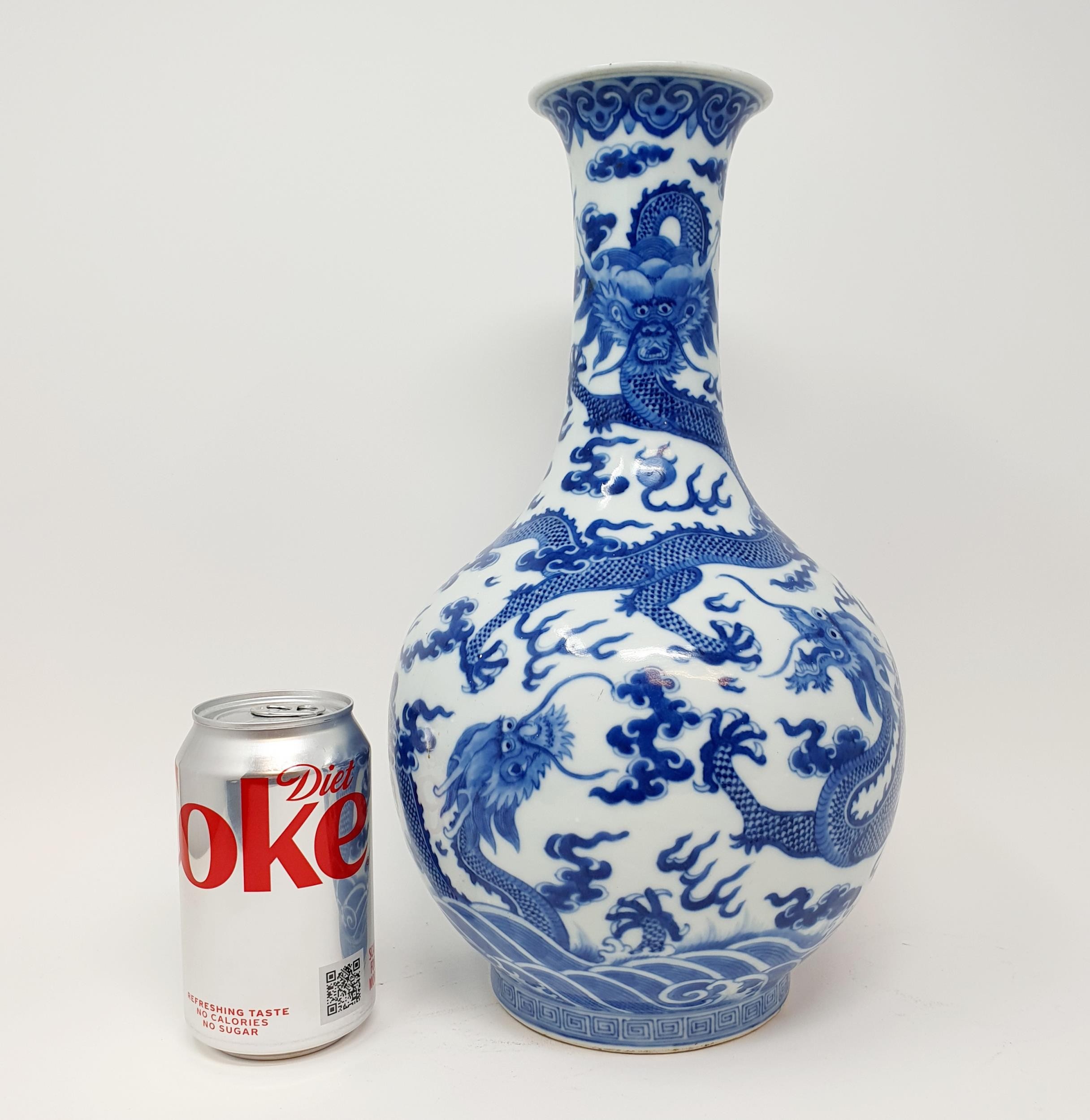 A Chinese underglazed blue and white vase, decorated dragons, 35 cm high Some firing faults, a