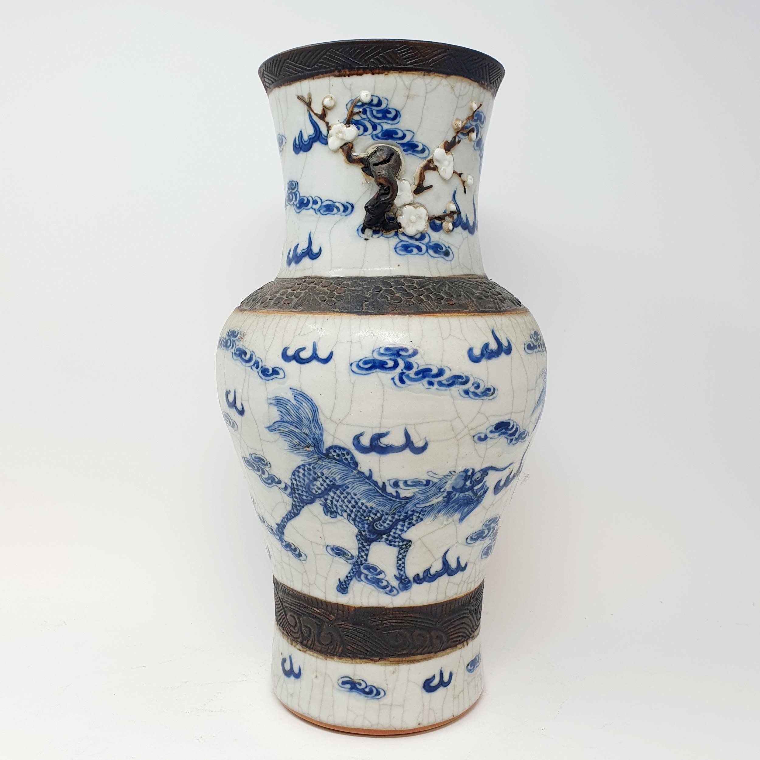 A Chinese underglazed blue and white vase, with a crackled glaze, decorated mythical beasts, 38 cm - Image 4 of 10