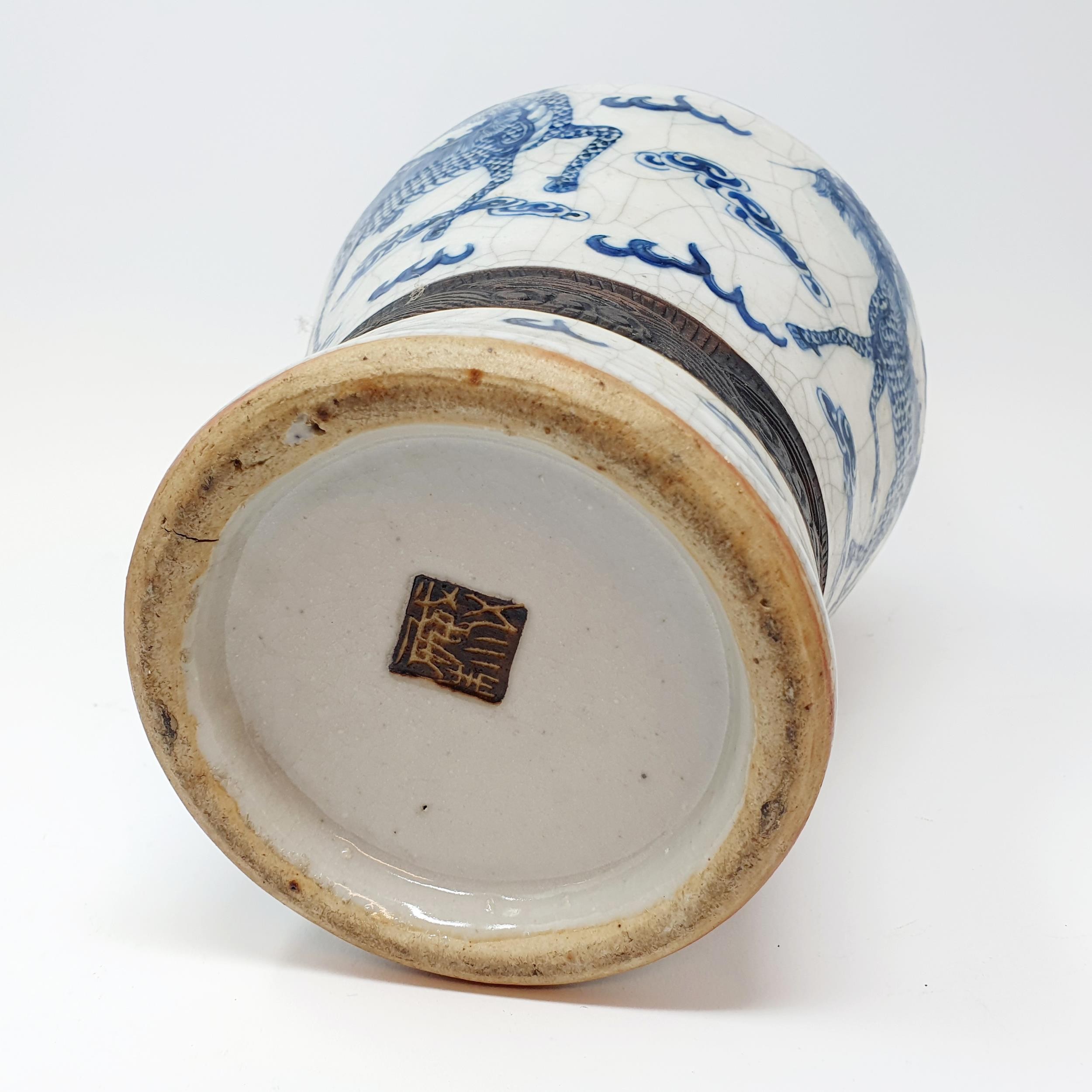A Chinese underglazed blue and white vase, with a crackled glaze, decorated mythical beasts, 38 cm - Image 8 of 10