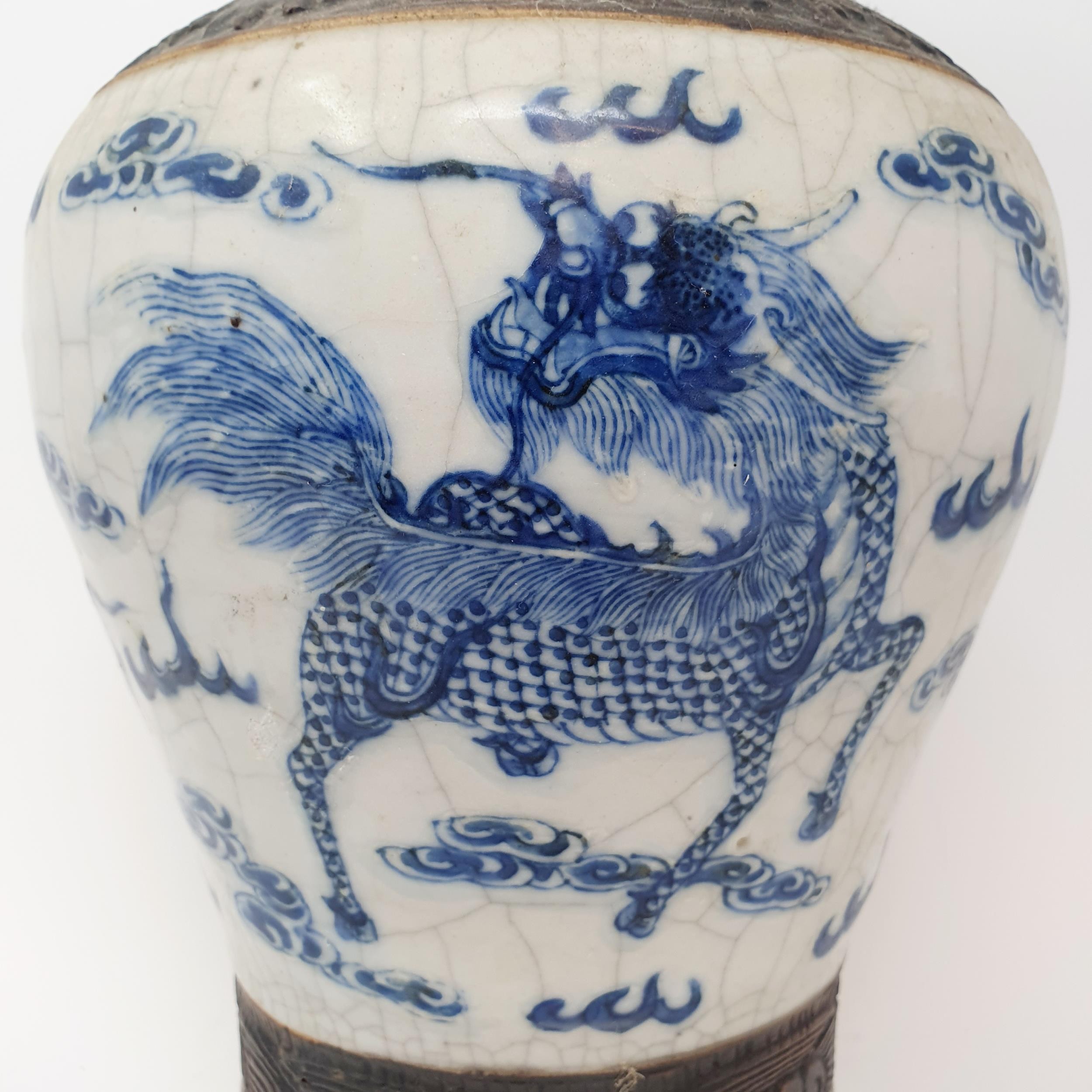 A Chinese underglazed blue and white vase, with a crackled glaze, decorated mythical beasts, 38 cm - Image 2 of 10