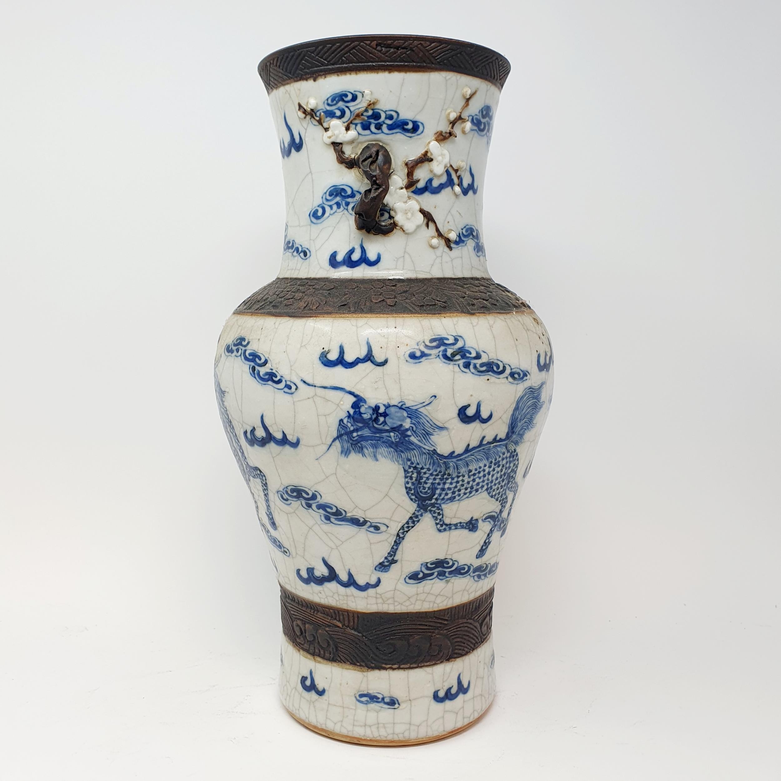 A Chinese underglazed blue and white vase, with a crackled glaze, decorated mythical beasts, 38 cm - Image 7 of 10