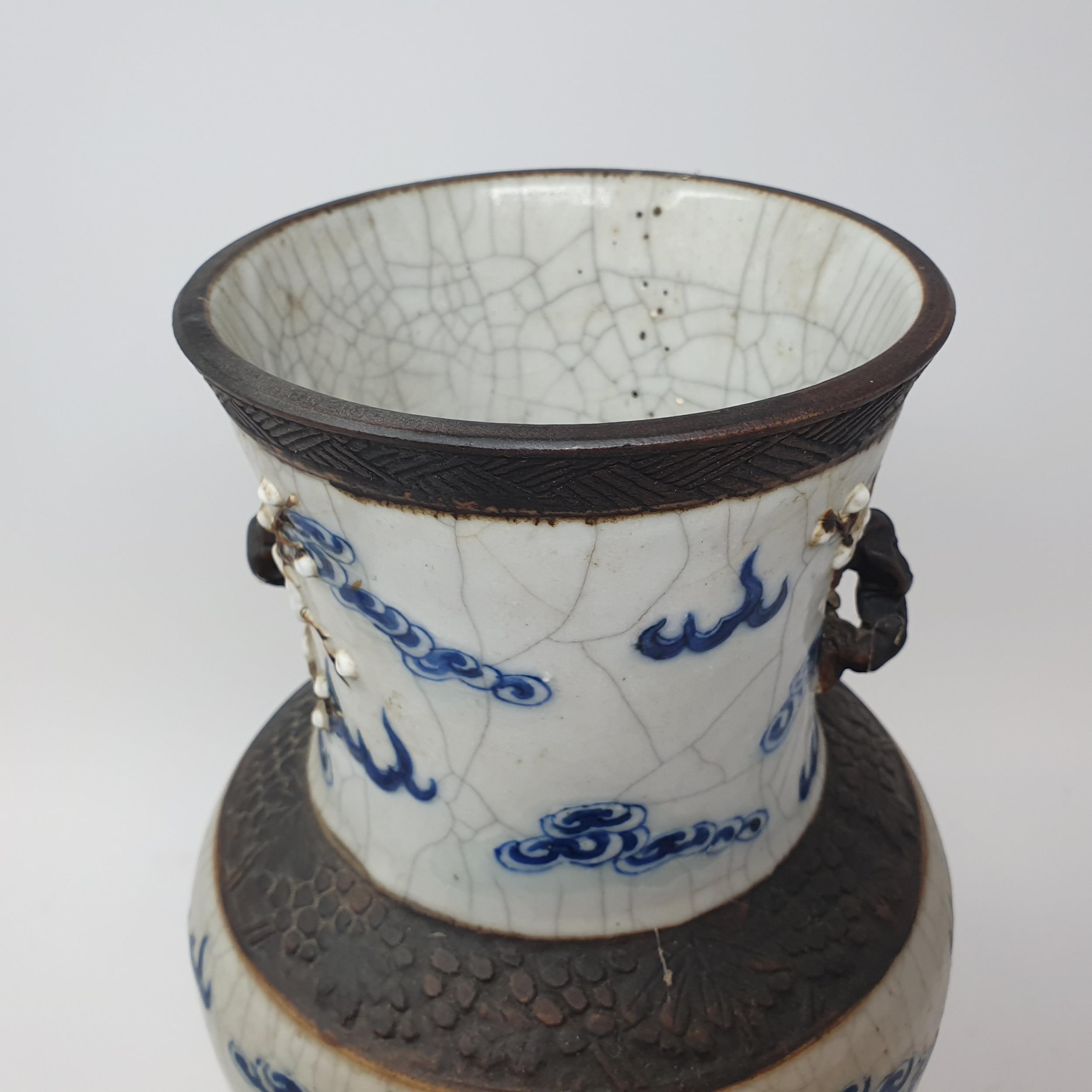 A Chinese underglazed blue and white vase, with a crackled glaze, decorated mythical beasts, 38 cm - Image 10 of 10