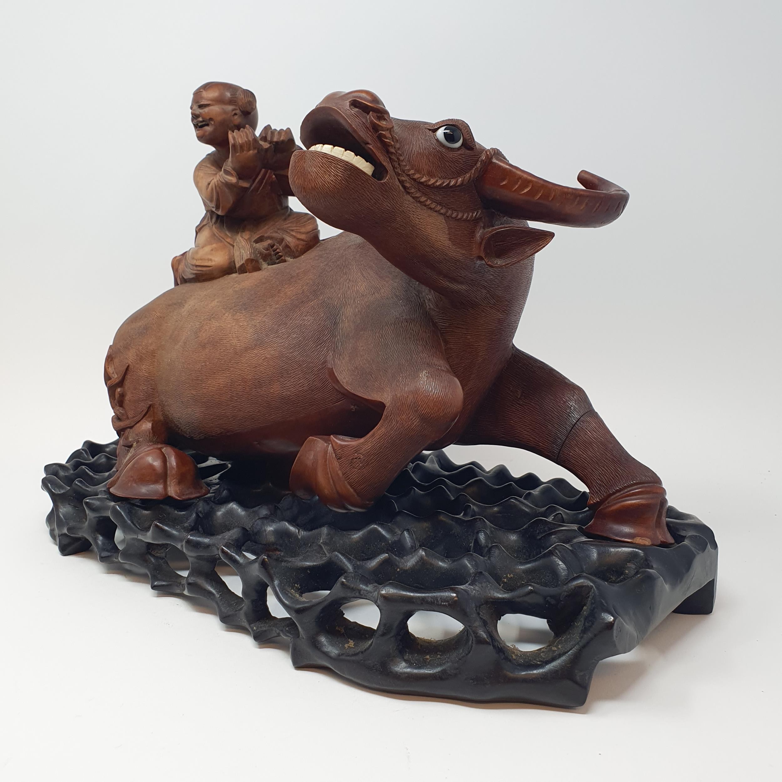 A Chinese carving of a water buffalo, with a seated figure, on a hardwood stand, 40 cm high - Image 4 of 7