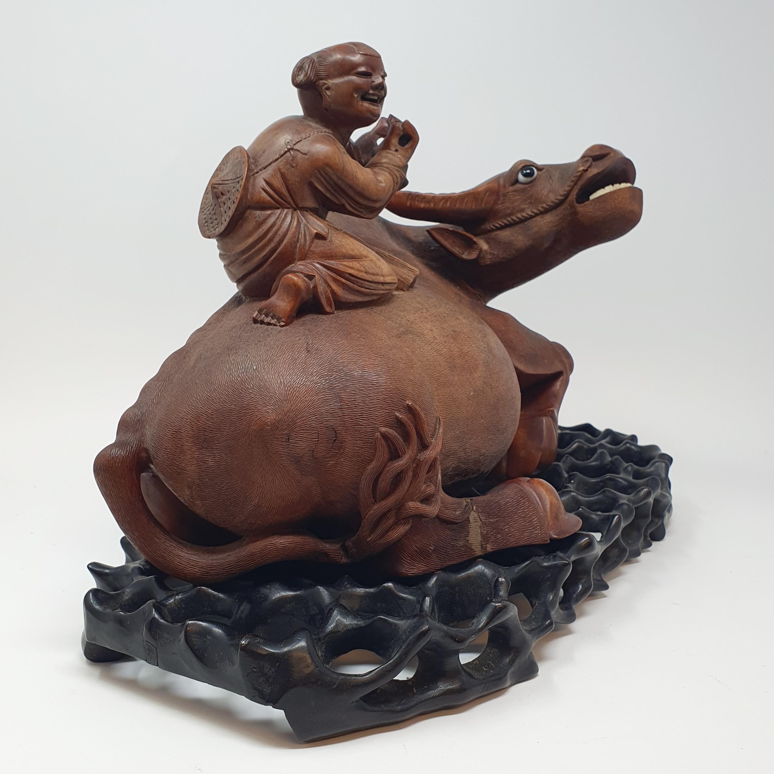 A Chinese carving of a water buffalo, with a seated figure, on a hardwood stand, 40 cm high - Image 6 of 7