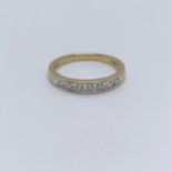 An 18ct gold and diamond half eternity ring, ring size O inside engraved 'Forever'