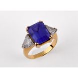 An 18ct gold, blue tanzanite and trilliant cut diamond three stone ring, ring size H 1/2 Provenance: