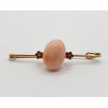 A yellow metal and pink stone bar brooch