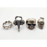 A silver coloured metal gentleman's ring, in the form of a scorpion, two other rings, and a skull