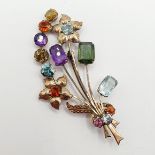 A multi-coloured gem set floral brooch