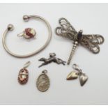 A silver coloured metal brooch, in the form of a dragonfly, and assorted other jewellery