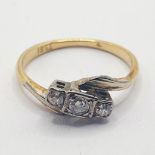 An 18ct gold, and three stone diamond ring, ring size L
