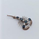 A 9ct gold, blue and white stone scorpion brooch