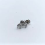 A pair of diamond stud earrings Each diamond 3.9 mm diameter approx.