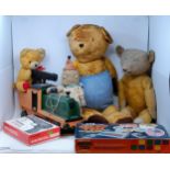 A well loved teddy bear, three others, and a painted pull-along locomotive (box)