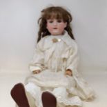 An Armand Marseille bisque headed doll, with closing millefiori glass eyes and a jointed composite