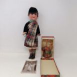 An Armand Marseille bisque headed doll, No. 390, in a Scottish costume with bagpipe We also have a