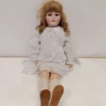 A German bisque headed doll, makers mark BSW, with millefiori closing eyes and a composite body,