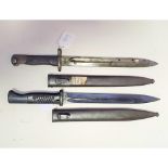 A bayonet and scabbard, and another (2)
