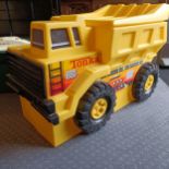 A large Tonka toybox, in the form of a dumper truck, an Alpha Probe spaceship, a Seaga Lock-On laser