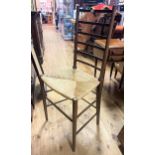 An early 20th century oak ladder back chair, with a reeded seat