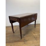 An early 19th century mahogany Pembroke table, in teh manner of Gillow, on tapering reeded legs, 110